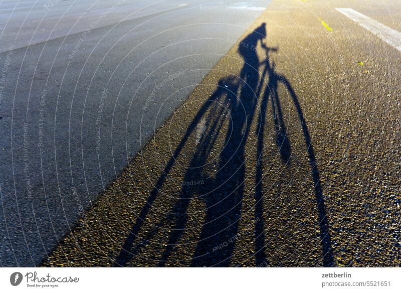 Shadow (bicycle) Evening Berlin Twilight Bicycle Closing time Far-off places Trajectory Airport Airfield Freedom Spring Sky Horizon Light Deserted Wheel taxiway