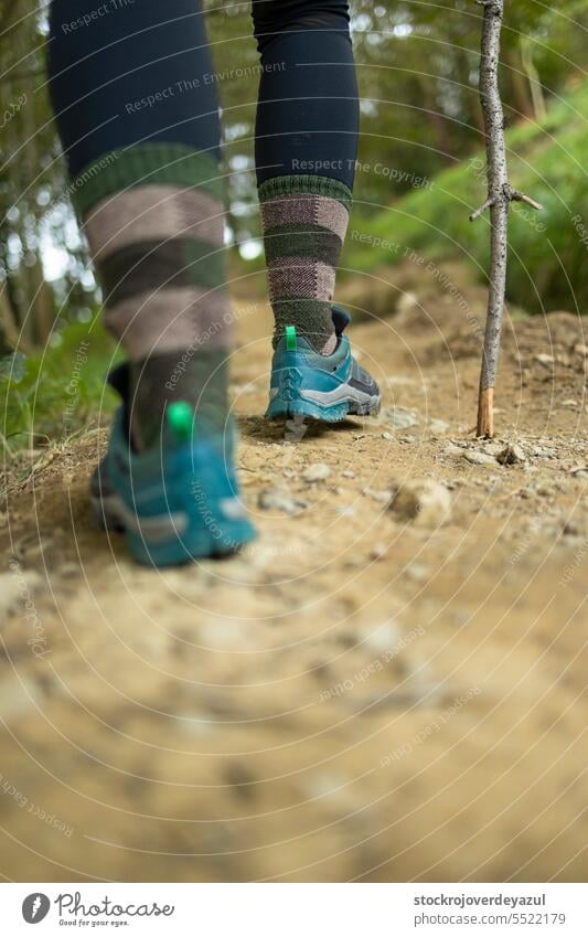 Detail of the feet and boots of a woman hiker, while walking along a trail, in the middle of nature basque country euskadi pagasarri sport person path mountain