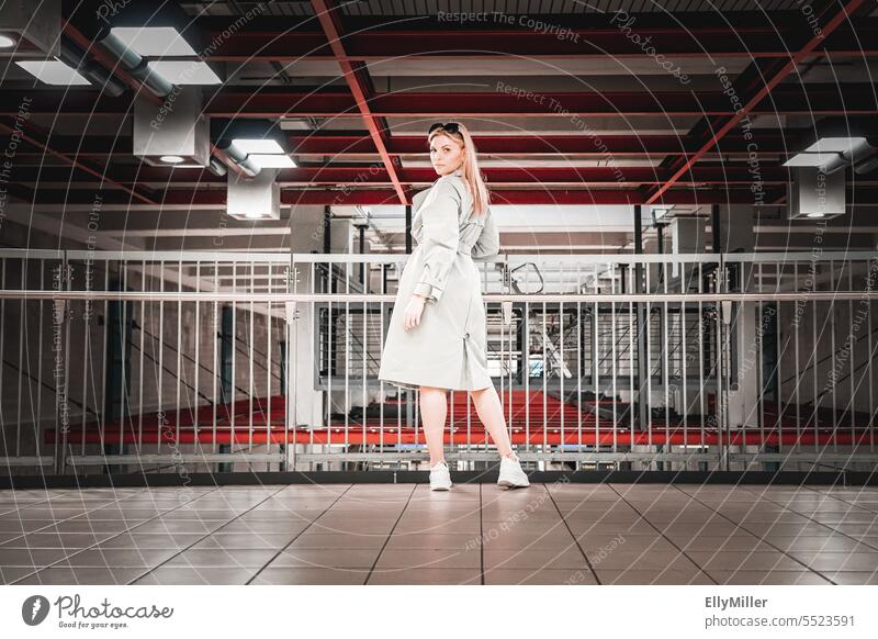 Portrait of young blonde woman at train station Woman portrait youthful Blonde feminine Attractive Face Emanation Self-confident Emotions Long-haired Authentic