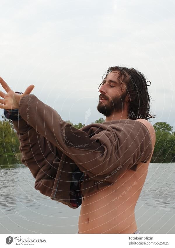 young man puts on a sweater after an ice-cold bath Man youthful bathe Cold Sweater Attract Swimming lake Lake Water Swimming & Bathing Wet salubriously fit