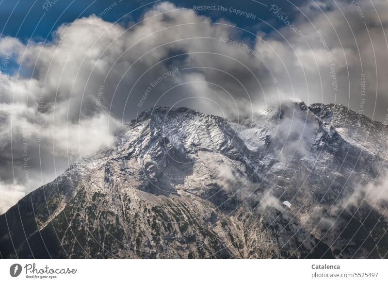 Fresh snow on the summit, clouds in the sky. Beautiful weather Deserted Nature Day Rock Environment Snowcapped peak Sky mountains Peak Landscape Clouds Alps