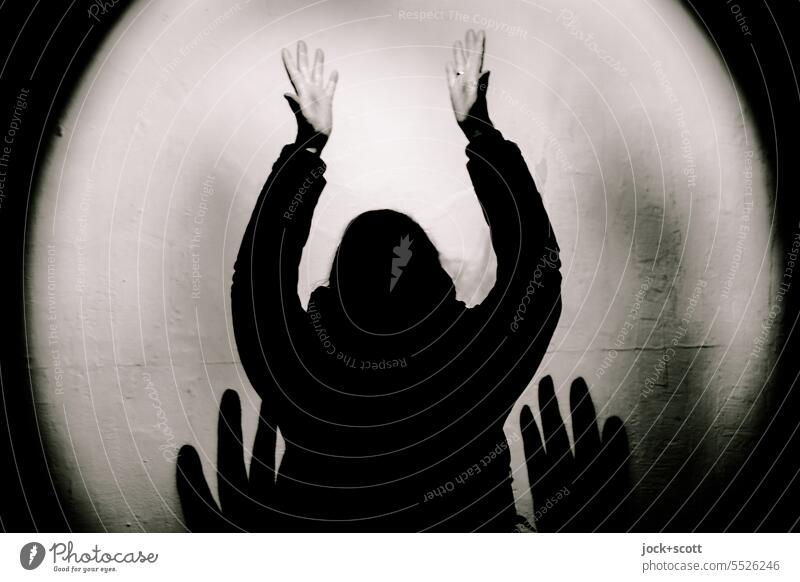 Hands up in spotlight Hands up! limelight Woman Human being Shadow Wall (building) Center point Contrast Silhouette Monochrome Symmetry attention Concentrate