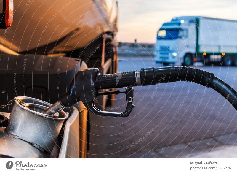 Diesel nozzle from a gas station filling a truck tank, close-up. diesel fuel transport refueling petrol routine vehicle working energy hose charging handle