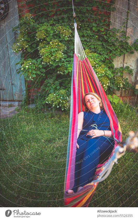 Portrait of young blonde woman smiling lying in hammock Woman Young woman Sympathy Congenial pretty pretty woman Attractive attractiveness smilingly Smiling