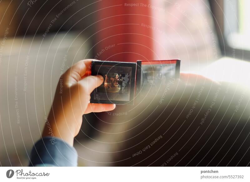 framed slides in children's hands. A child looks at slides on glass plates. Analog photography Slide analogue photography look at vintage Glass plates Marvel