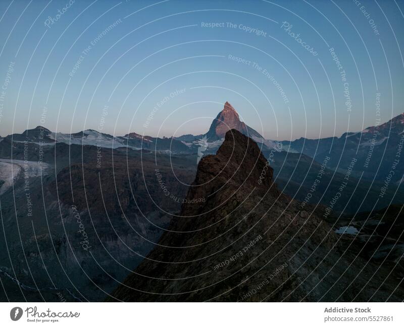 Misty peaks in dusky mountainous terrain valley rock evening ridge rough tranquil rocky nature switzerland matterhorn scenic twilight peaceful landscape cliff