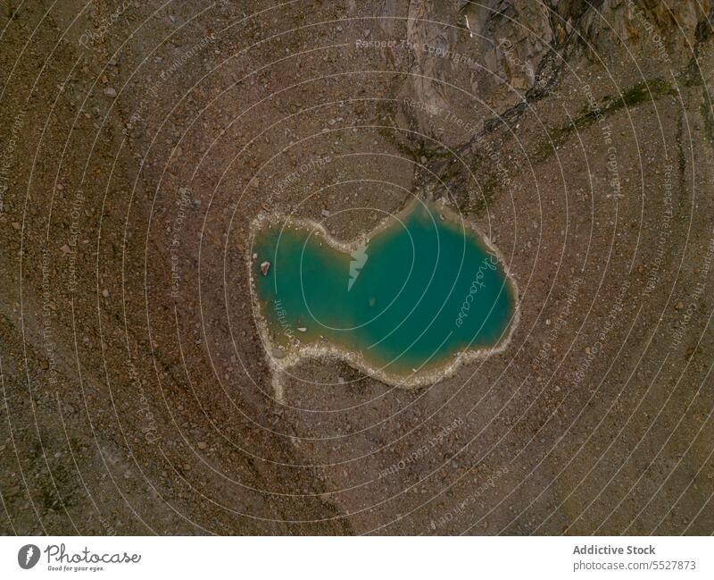 Small lake in arid terrain of mountains valley environment dry sunlight landscape rock scenic water swiss alps majestic turquoise scenery tranquil nature