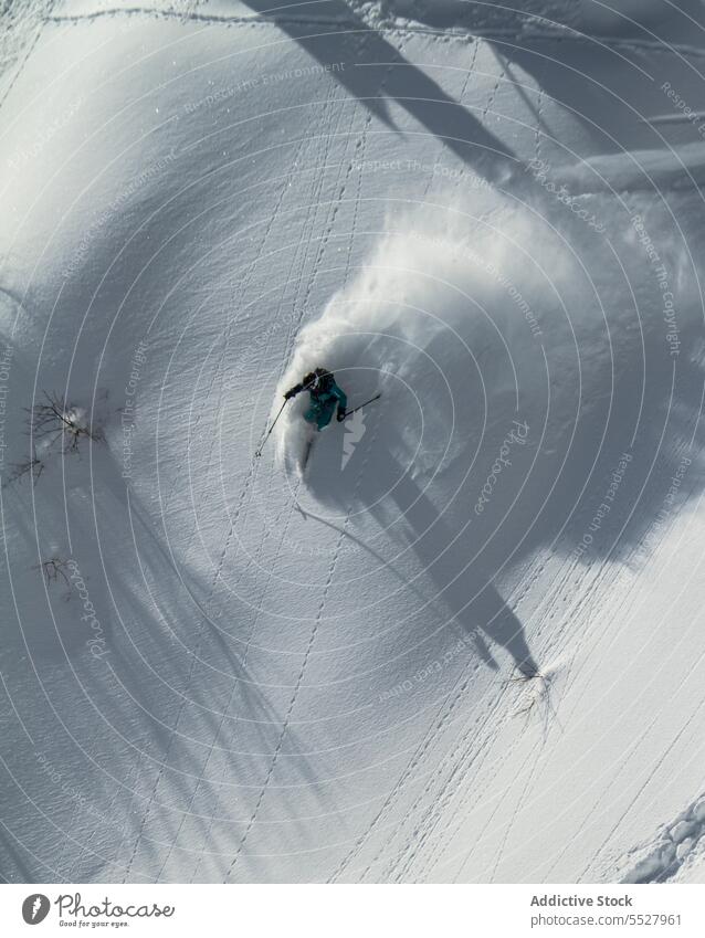 Anonymous man skiing on winter day ride snow resort extreme outwear cold sport vacation lifestyle recreation frost male cool daytime activity mountain season