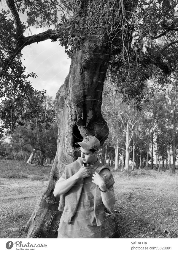 Black and white capture of a handsome young man Photography Black & white photo photogenic Model Shirt Hat hoodie Cap T-shirt Looking posing modeling