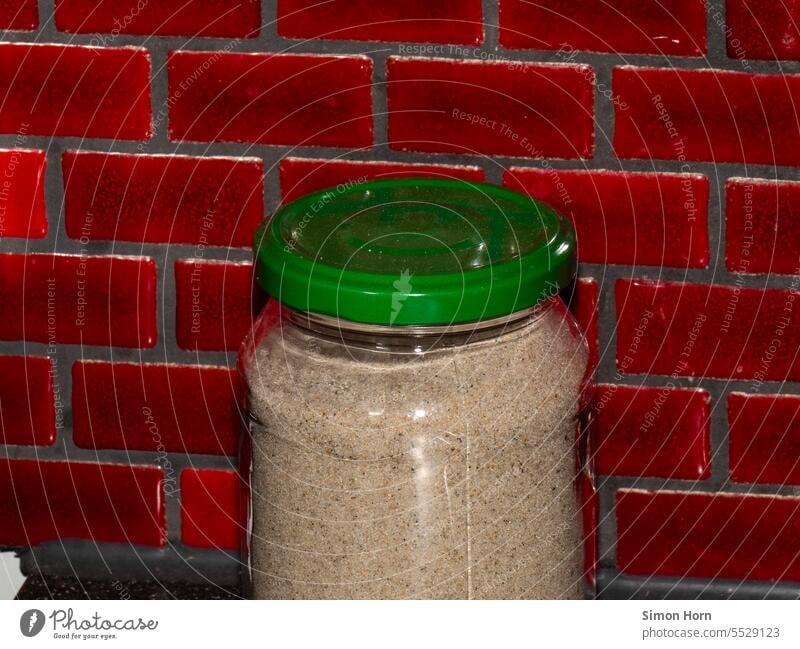 Sand in a glass container in front of red tiles Memory safekeeping preserved memory Souvenir Vacation & Travel Review Beach Nostalgia Longing end of summer