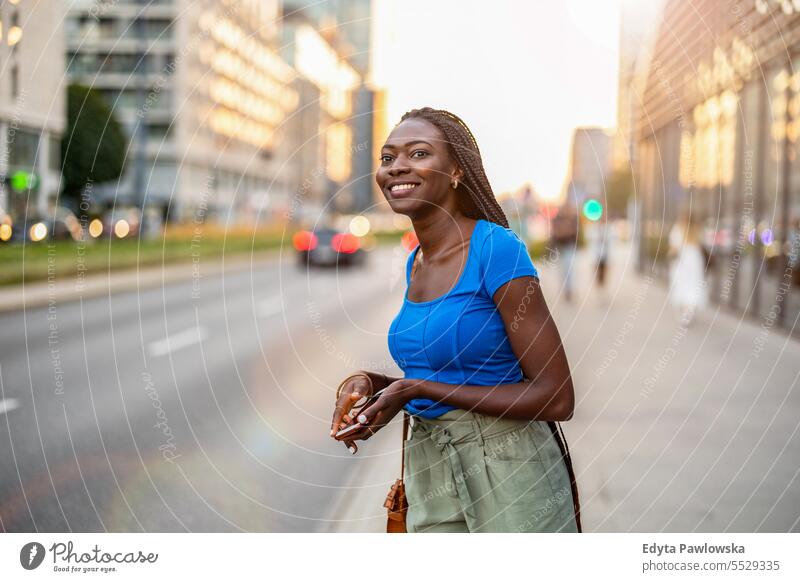 Portrait of a beautiful young woman smiling in the city adult attractive black confidence confident cool female girl hairstyle leisure lifestyle natural