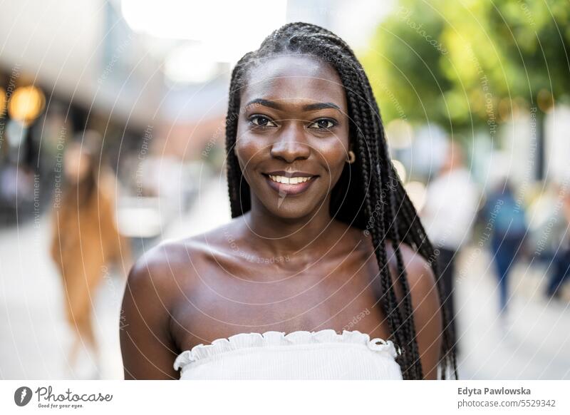 Portrait of a beautiful young woman smiling in the city adult attractive black confidence confident cool female girl hairstyle leisure lifestyle natural