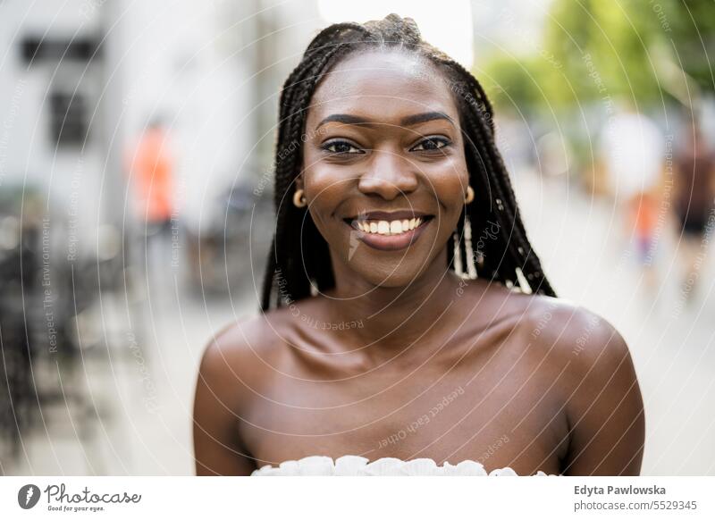 Portrait of a beautiful young woman smiling in the city adult attractive black confidence confident cool female girl hairstyle leisure lifestyle natural