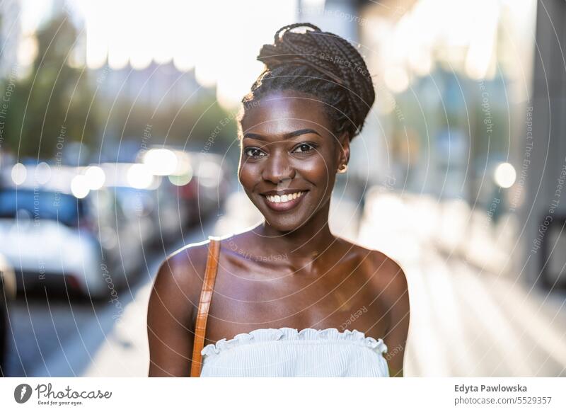 Portrait of a beautiful young woman smiling in the city adult attractive black confidence confident cool female girl hairstyle leisure lifestyle natural