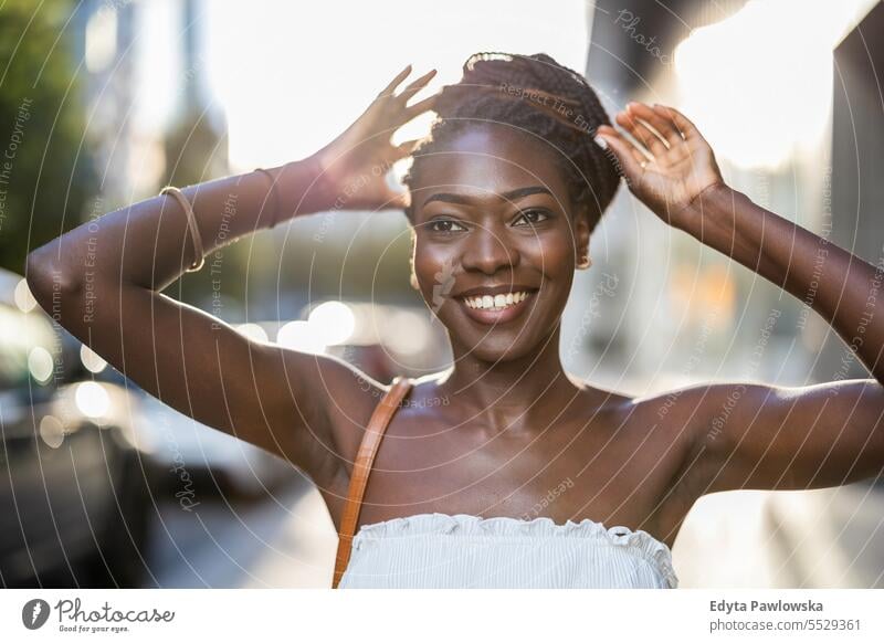 Portrait of a beautiful young woman smiling in the city adult attractive black confidence confident cool female girl hairstyle leisure lifestyle natural