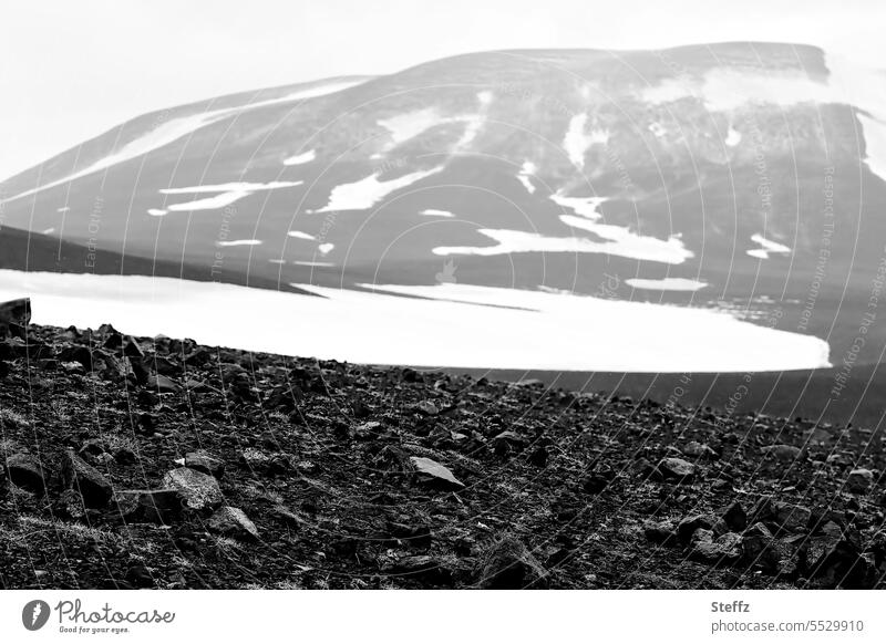 Snow, stones and rocky hills in Iceland North Iceland Iceland picture Rock Hill Hill side mountain residual snow Boulders Rock mound hilly rock formation