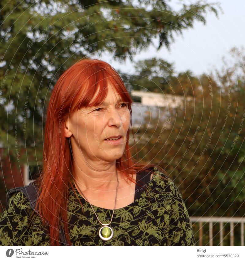 Wide land | skeptical look Woman Human being portrait feminine Feminine Long-haired Red-haired out Exterior shot Sunlight Evening sun Colour photo Adults