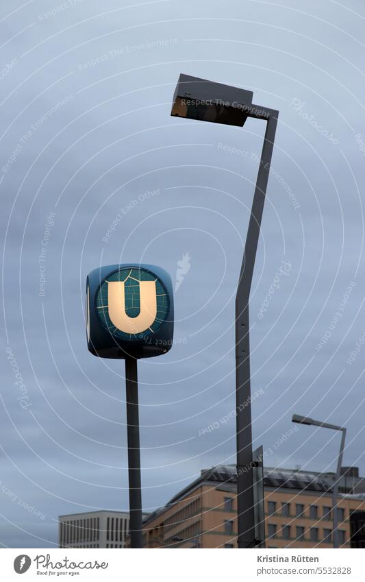 bent street light at lighted u U Underground Subway Stop (public transport) Station illuminated sign Clue mark typography Illuminated streetlamp Lantern