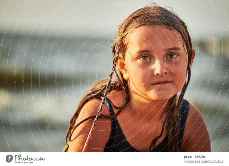 Portrait of little girl playing in the sea. Child wearing swimsuit enjoying summer vacation on the beach vacations ocean splashing fun child kid playful travel