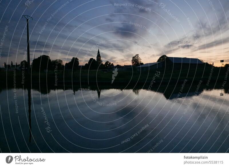 Evening mood sky and water _ skyline of a village reflected in water body Church spire Village Sky Water silouette Architecture Pole Electricity pylon Skyline