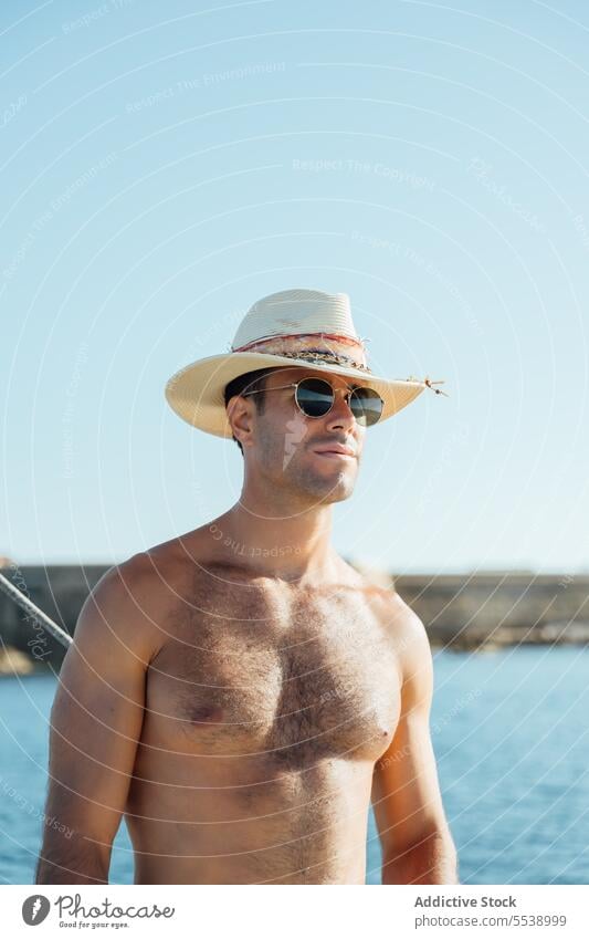 Handsome man on sailboat in the ocean yacht sensual summer vacation confident sensuality cruise body dreamer stylish vessel model outdoors male natural fit