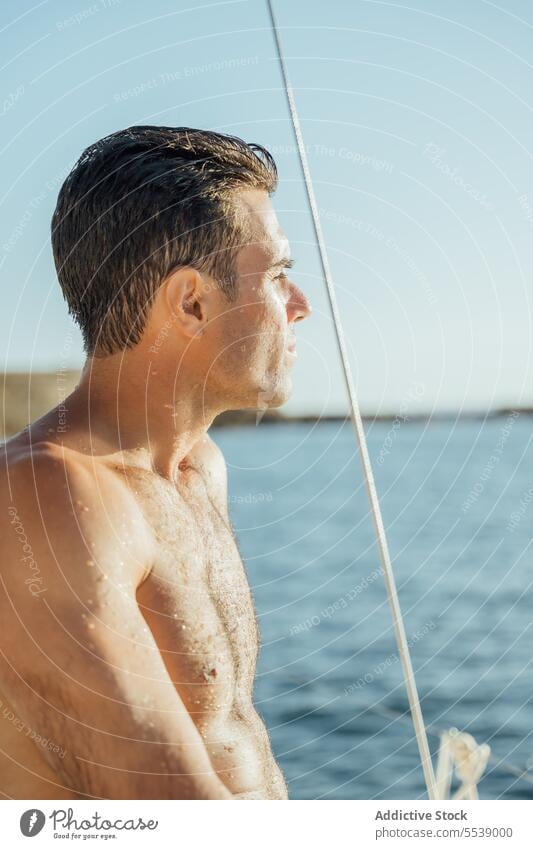 Handsome man on sailboat in the ocean yacht sensual summer vacation confident sensuality cruise body dreamer stylish vessel model outdoors male natural fit