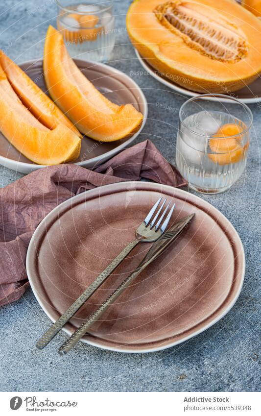 Sliced fresh orange musk melon fruit with melon spheres served on table slice glass healthy food delicious tasty portion organic cold refreshment cut knife