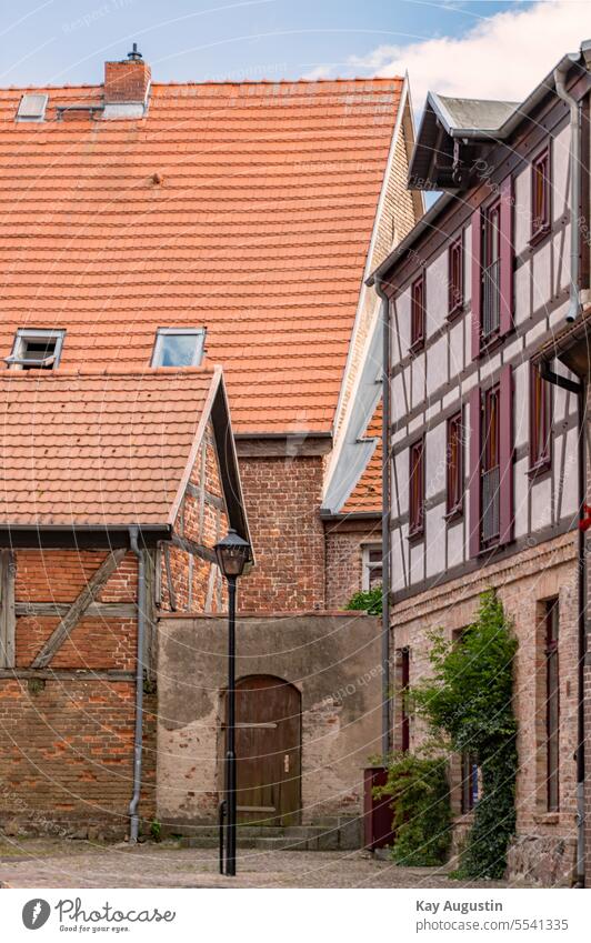 Picturesque alley with lantern Alley in Waren Old town Half-timbered house Old town alley Historic variegated Facades Building lamps Street lighting