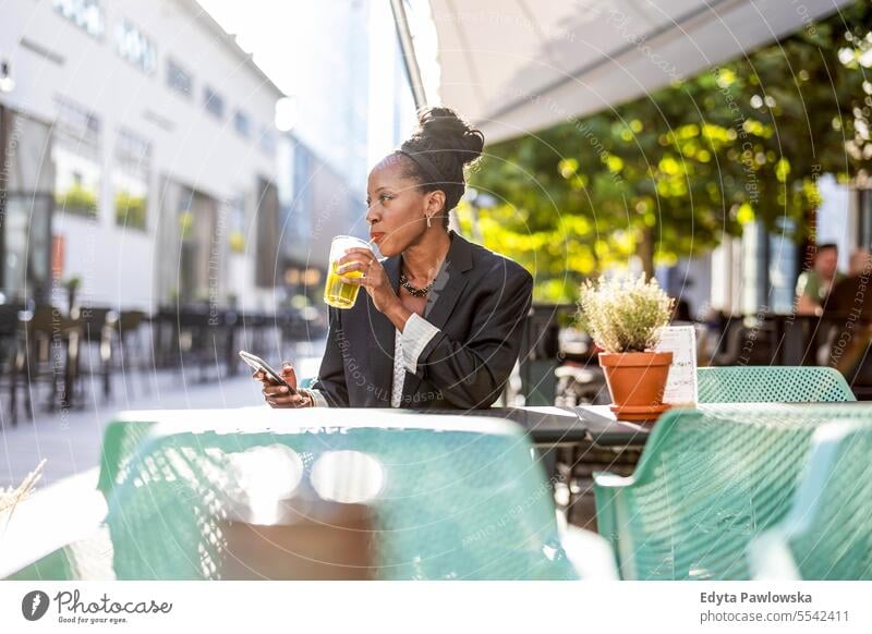 Portrait of a mature businesswoman sitting in an outdoor cafe people downtown joy urban black natural attractive city black woman happiness street happy modern