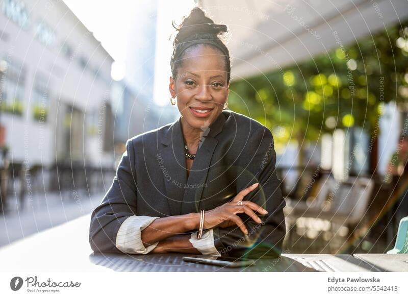 Portrait of a mature businesswoman sitting in an outdoor cafe people downtown joy urban black natural attractive city black woman happiness street happy modern