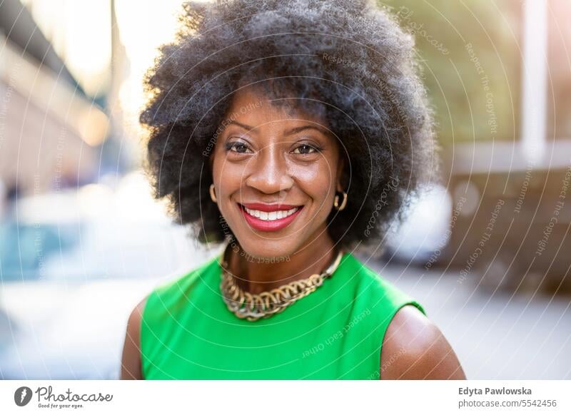 Portrait of a mature woman wearing green dress standing in the city people downtown businesswoman joy urban black natural attractive black woman happiness