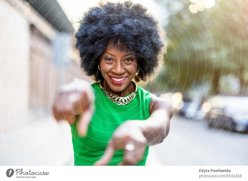 Portrait of a beautiful young woman gesturing outdoors people downtown businesswoman joy urban black natural attractive city black woman happiness street happy