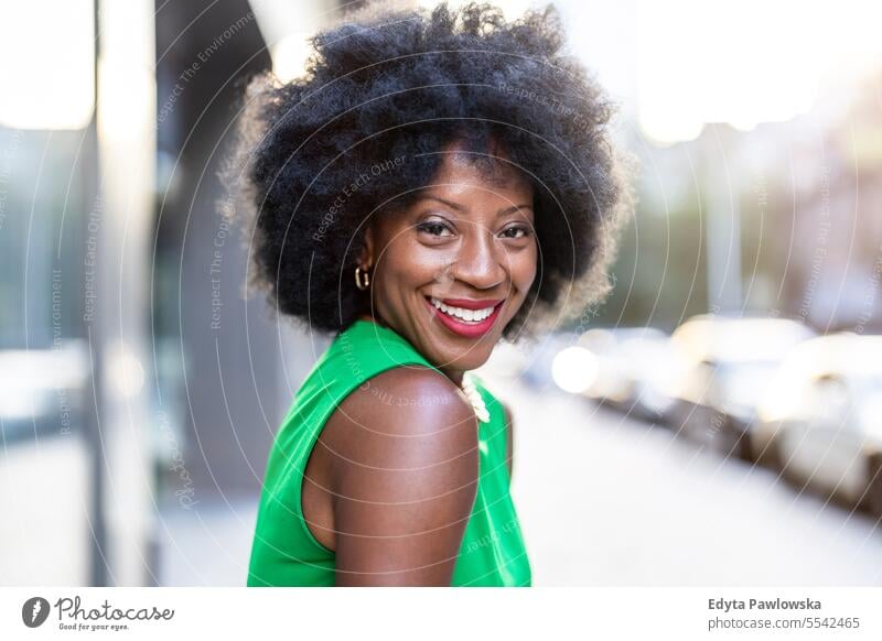 Portrait of a mature woman wearing green dress standing in the city people downtown businesswoman joy urban black natural attractive black woman happiness