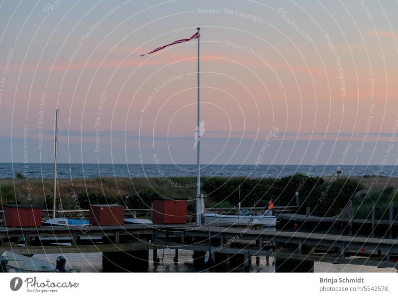 a small harbour with boats and tiny houses in the evening in Boderne, Bornholm, Denmark vacation fisherman beach outdoor adventure relaxing seascape marina