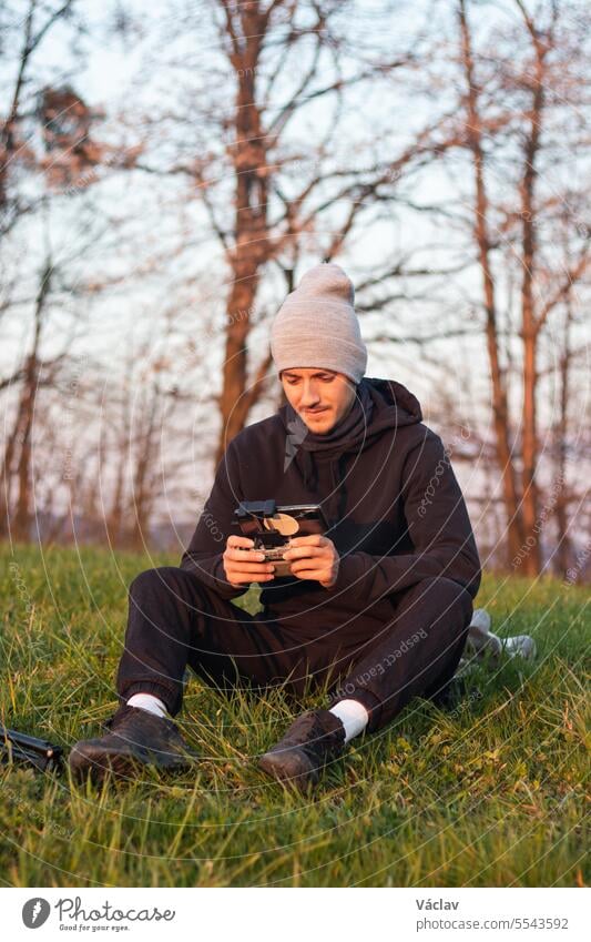 Young cinematographer shoots parts of a film using a technological product called a drone. Recording the sunset from an aerial view user human transportation