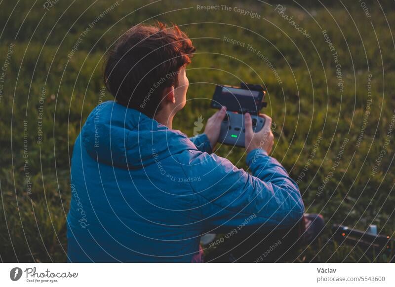 Young cinematographer shoots parts of a film using a technological product called a drone. Recording the sunset from an aerial view user human transportation