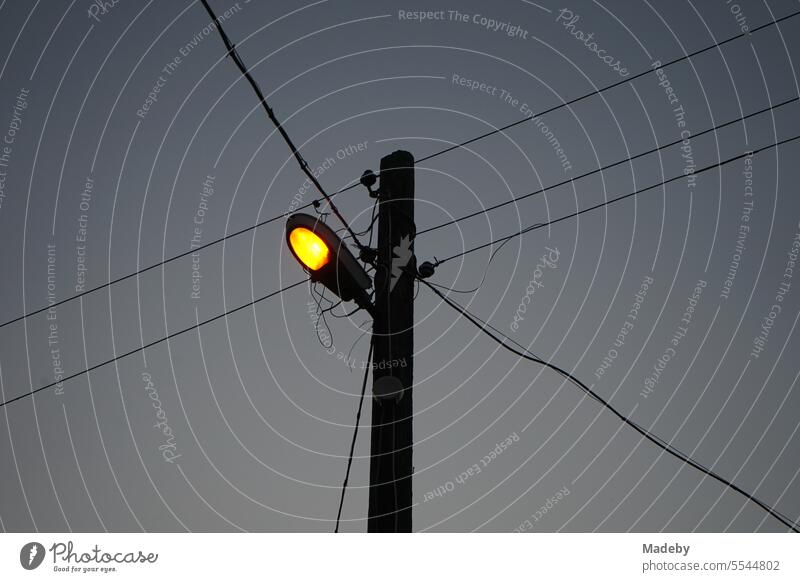 Power lines with street lighting on a line pole in the evening in the village of Maksudiye near Adapazari in Sakarya province, Turkey adapazari streetlamp