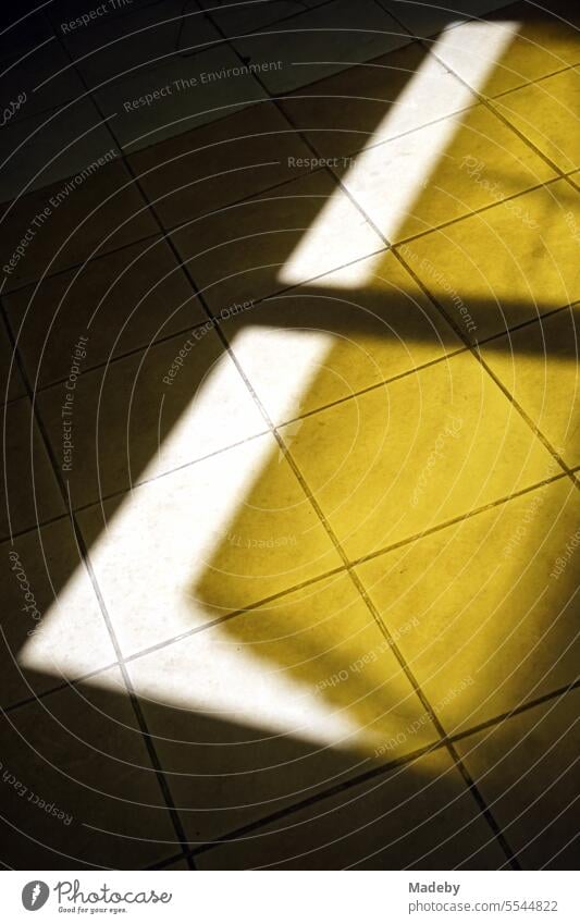 Light and shadow of a window with awning as a sunshade in summer sunshine on the floor of the traditional bazaar in Adapazari, Sakarya province, Turkey