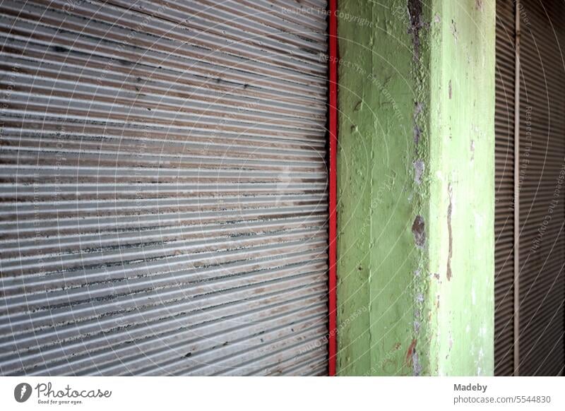 Roller shutter lowered in front of dirty and closed old store and store in traditional old bazaar in Adapazari, Sakarya province, Turkey Closed Load business