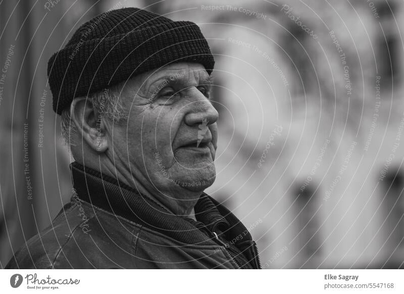 Exterior shot of a man alone against blurred background black and white photo Man Only one man Adults portrait Masculine Contrast Face Looking into the camera