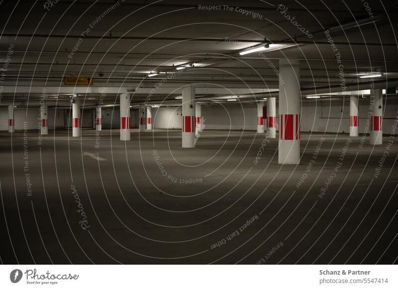 empty dark parking garage with round columns Underground garage Parking Town Gray Neon light Deserted Concrete Parking garage Garage Parking lot Parking level