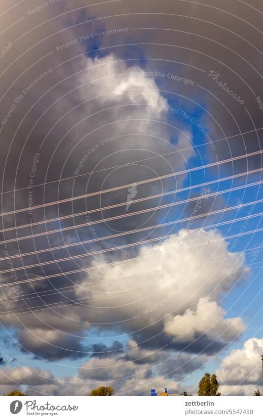 High voltage power line in front of clouds altocumulus Menacing Dark Twilight somber colour spectrum Closing time Worm's-eye view Thunder and lightning