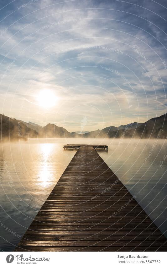 Sunrise at lake Fuschlsee in Austria at wooden jetty Lake wooden walkway Morning Water Salzkammergut Nature Landscape Mountain Idyll Lakeside Calm Reflection