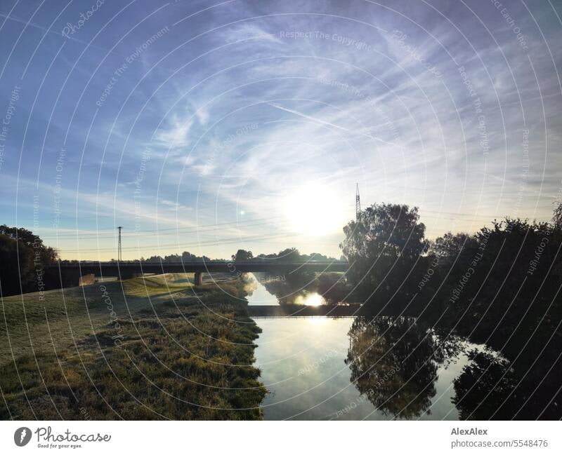 The Imenau from half above with bridge in the backlight, in the morning between dikes and meadows, dew and hoarfrost, beautiful weather Ilmenau River River bank