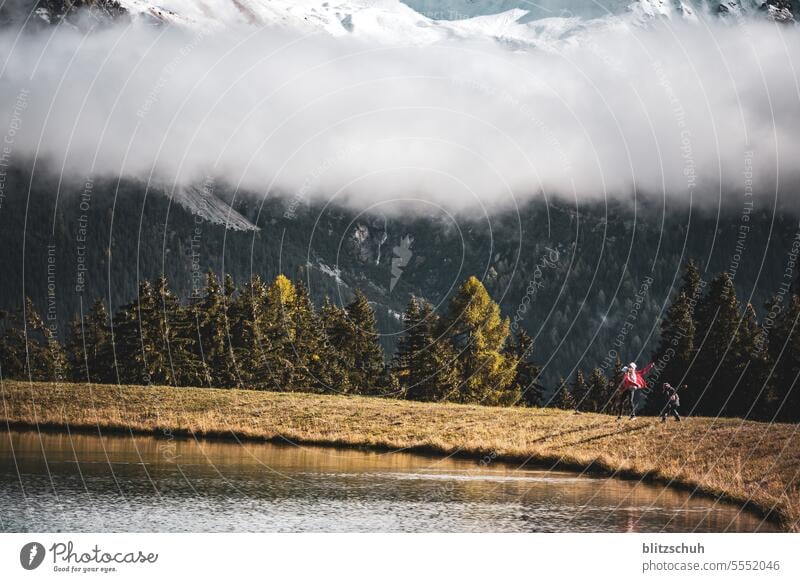 Children playing at a reservoir Mountain Nature Tourism Landscape Vacation & Travel Snow Alps Clouds Rock mountains Peak Environment Freedom Lenzerhorn Grisons