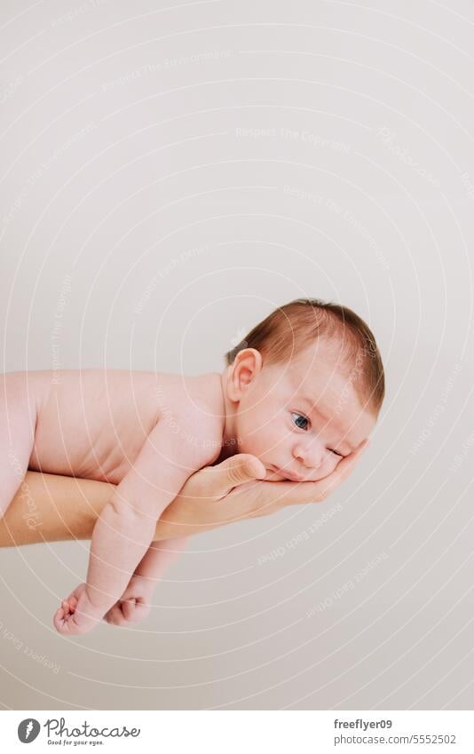 A newborn on his fathers hand against white baby firstborn portrait laying laying down copy space parenthood motherhood innocence life labor young boy happy