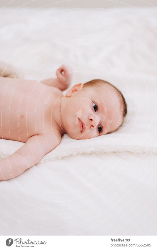 newborn in studio lighting against white baby firstborn portrait laying laying down copy space parenthood motherhood innocence life labor young boy happy small