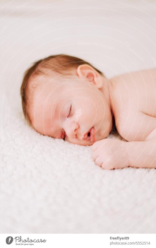 portrait of a newborn asleep in studio lighting baby firstborn laying laying down copy space parenthood motherhood innocence life labor young boy happy small