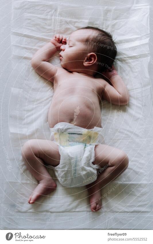 Portrait of a newborn on diapers on a baby changer sleeping asleep copy space parenthood motherhood innocence life labor young boy happy small pregnancy little