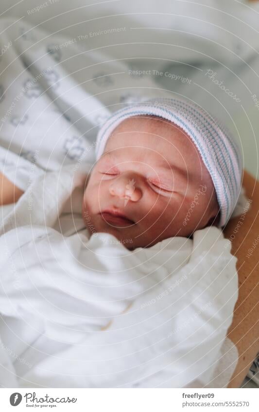 Portrait of a one day old newborn in the hospital baby portrait sleeping copy space parenthood motherhood innocence life labor young boy happy small pregnancy